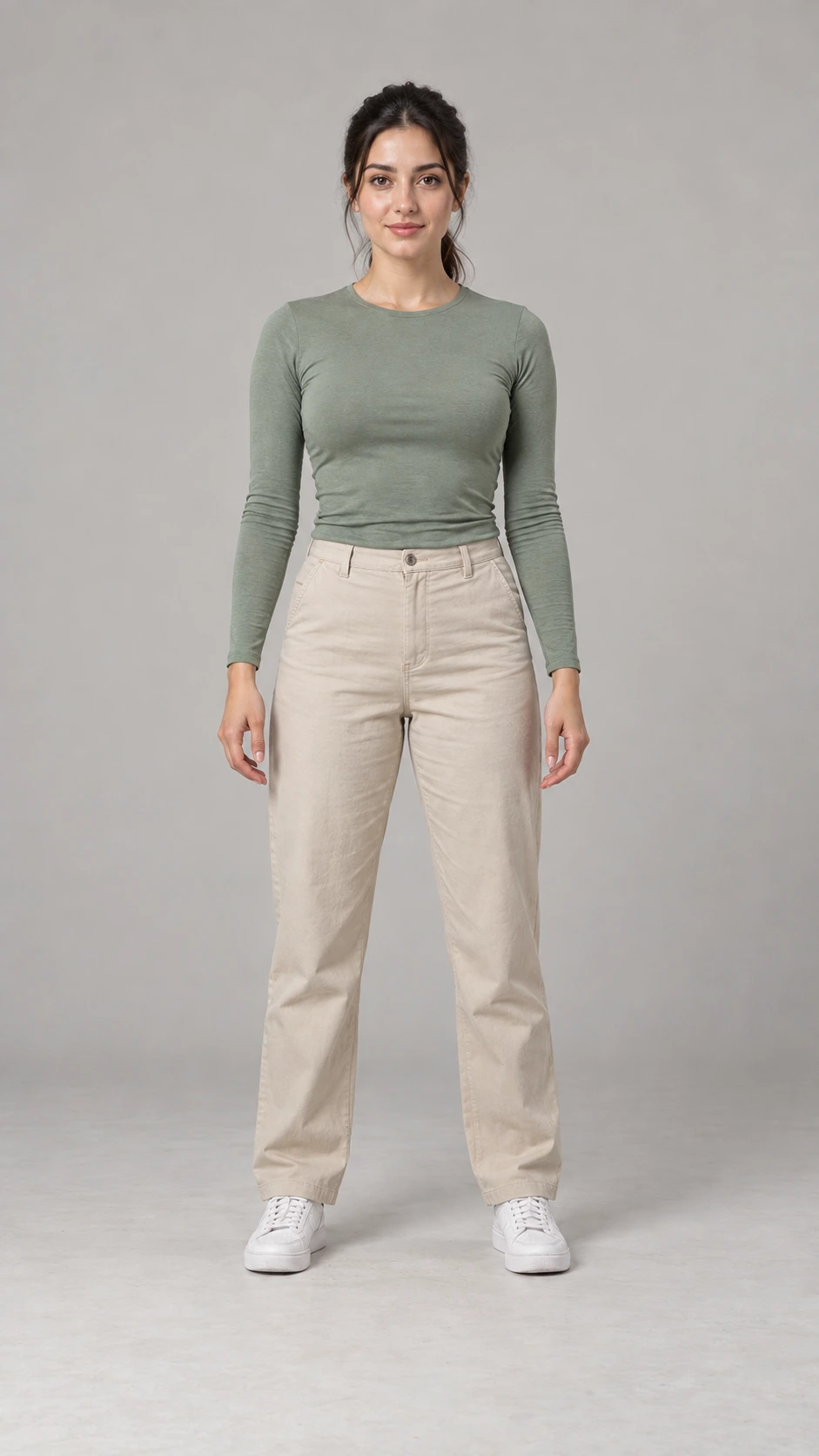 Fictional female creator in a sage top, beige trousers and white sneakers, shown head to toe