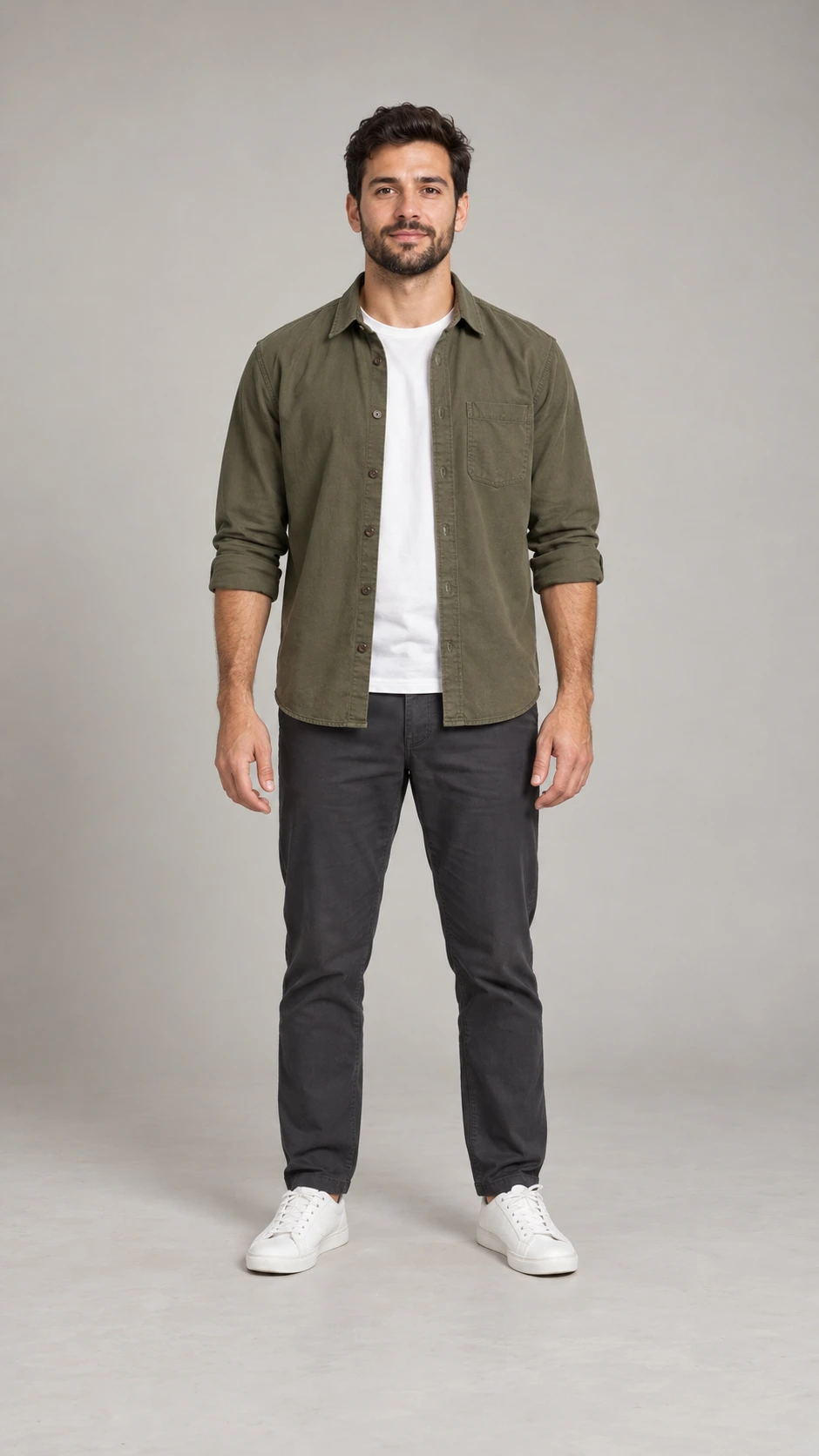 Fictional male creator in an olive overshirt, charcoal trousers and white sneakers, shown head to toe